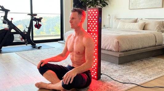 A man using the Fresh Healthcare Red Light PRO panel to treat his back, demonstrating safe positioning that naturally protects the eyes from direct light exposure