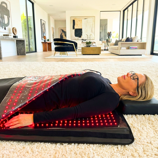 Person relaxing in Fresh Healthcare red light blanket in bright living room